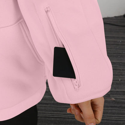 Close-up of a pink hoodie sleeve with an item in zipper pocket